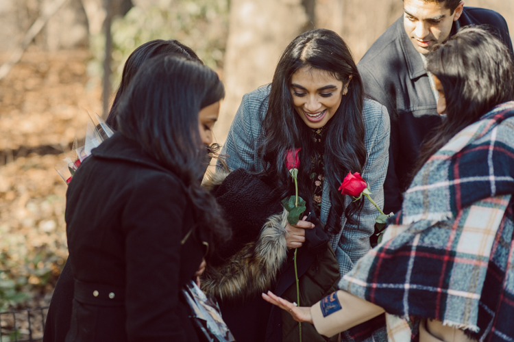 Nisha and Sagar's Ladies Pavilion Central Park NY proposal on a sunny sunday afternoon went just as Sagar planned it to be and more with their friends to celebrate together. Nisha and Sagar walked from their NYC apartment to Ladies Pavilion Central Park pretending to meet their friends for a pop up lunch but as soon as Nisha saw all her girlfriends standing by Ladies Pavilion holding roses, she quickly figured out what was about to happen. Then Sagar walked Nisha over into Ladies Pavilion where it was decorated with candles and rose pedals, Sagar went down on his one knee pulled out the ring. Watching Sagar go on his knee Nisha also went on her knee and received her ring while saying "Yes" and hugging him. All the emotions, tears hanging off her big round eyes. I truly felt so honored to be able to capture this special moment in their lives for them, documenting the beginning of their next chapter in life. Nisha and Sagar's Ladies Pavilion Central Park proposal captured by NY NJ Documentary Wedding Photographer Karis from Hey Karis, photographing your wedding, capturing your love and documenting your life.